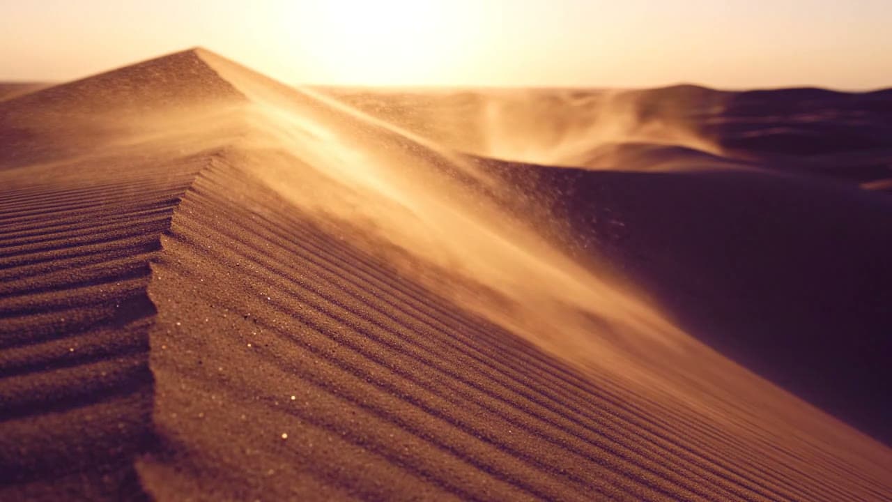 Golden Sand Streaming Over Desert Dunes